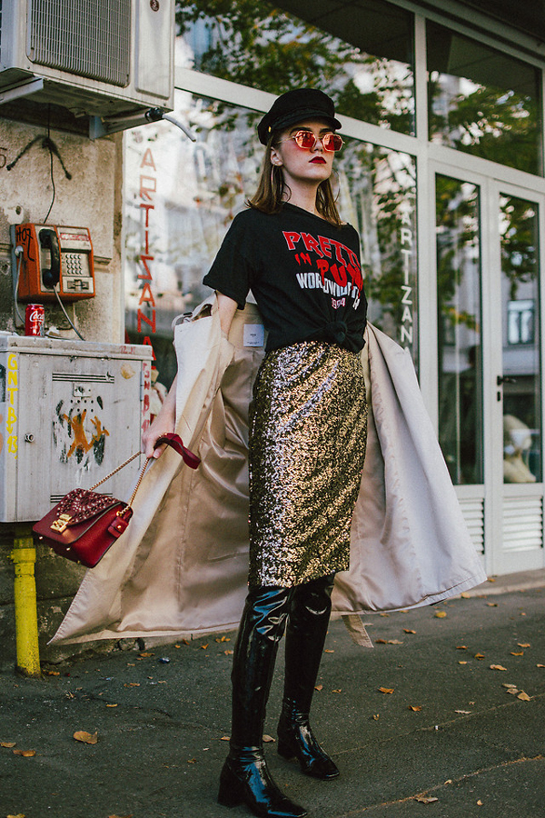 Túi xách nạm đinh tán ánh đồng được fashioniissta chọn để phối đồ khi sử dụng chân váy sequins mix cùng bốt da bóng, áo in họa tiết ấn tượng.
