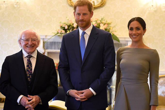 The couple posed alongside President Higgins after signing the guest book at his home in Ireland