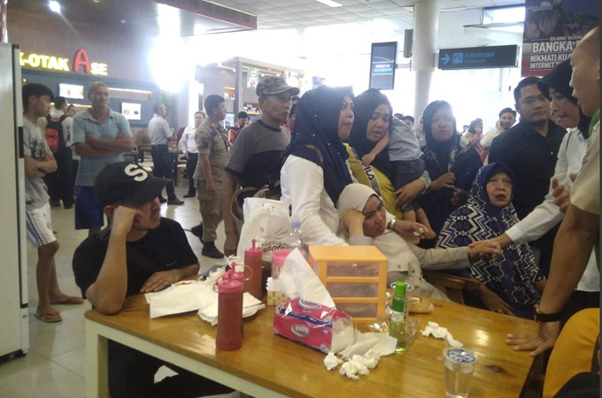 The relatives were seen comforting each other as they all waited as a group for news
